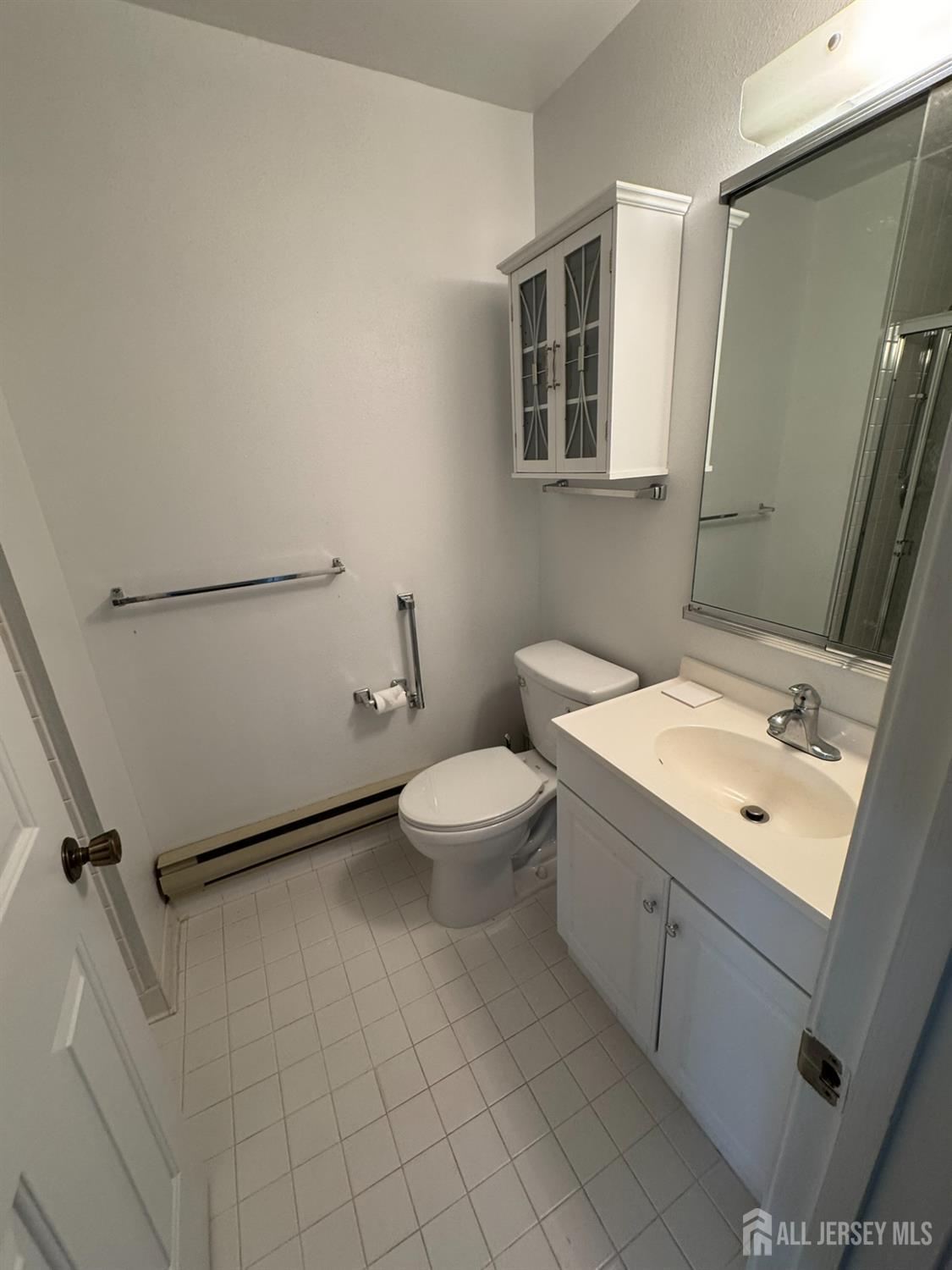 723 Mt Vernon Road, Unit A Monroe Township, NJ 08831 - Photo 15 of 19 a bathroom with a toilet sink and mirror