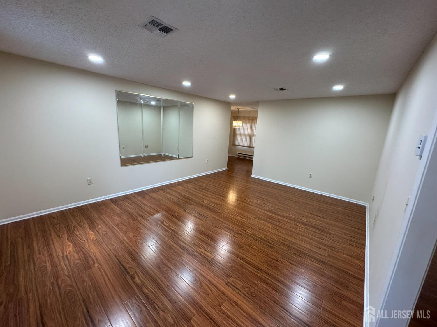 723 Mt Vernon Road, Unit A Monroe Township, NJ 08831 - Photo 2 of 19 an empty room with wooden floor and windows