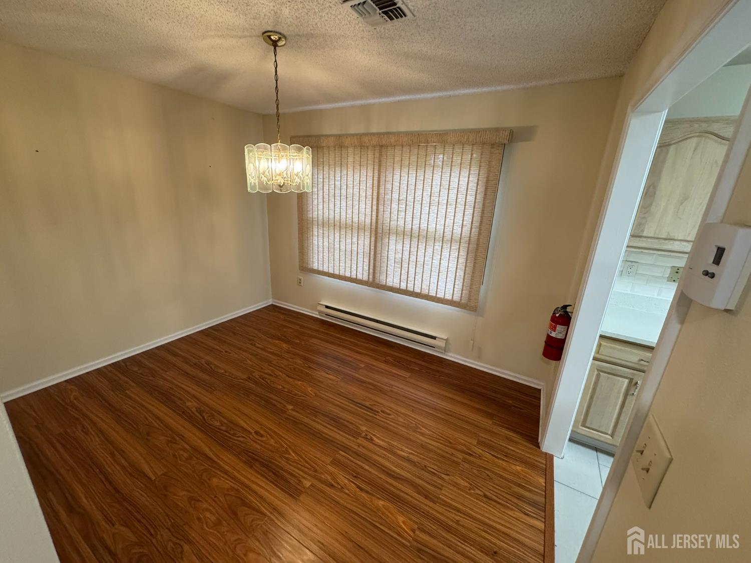 723 Mt Vernon Road, Unit A Monroe Township, NJ 08831 - Photo 4 of 19 a view of a room with wooden floor and chandelier