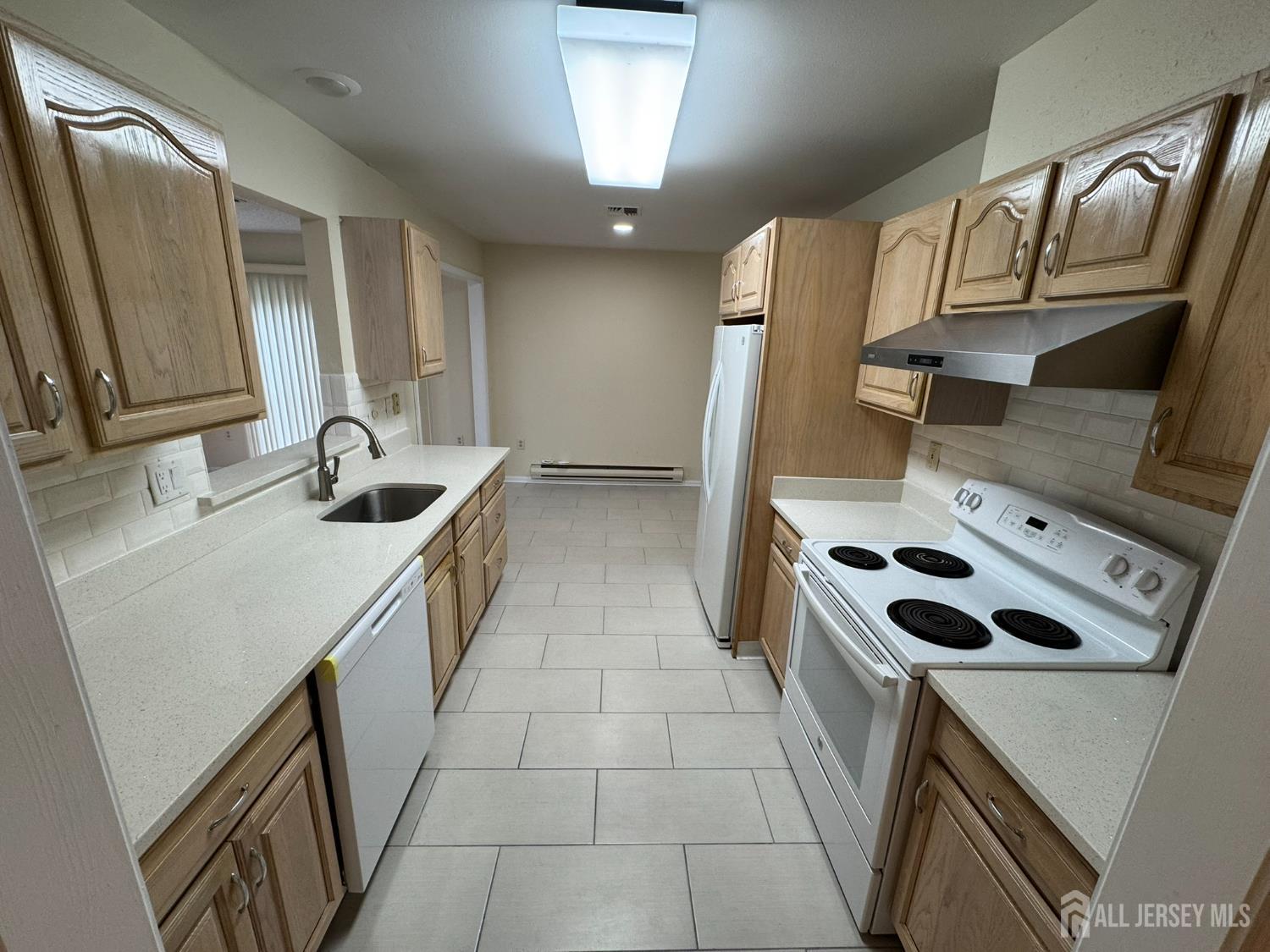 723 Mt Vernon Road, Unit A Monroe Township, NJ 08831 - Photo 6 of 19 a kitchen that has a sink a stove top oven and a refrigerator
