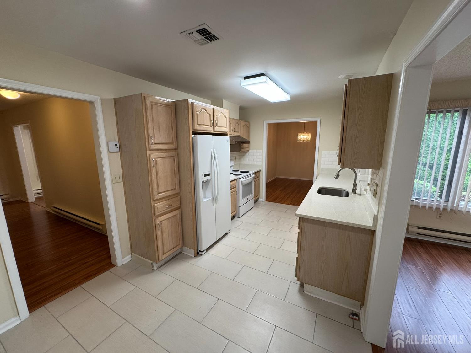 723 Mt Vernon Road, Unit A Monroe Township, NJ 08831 - Photo 7 of 19 a kitchen with a refrigerator sink and wooden floor