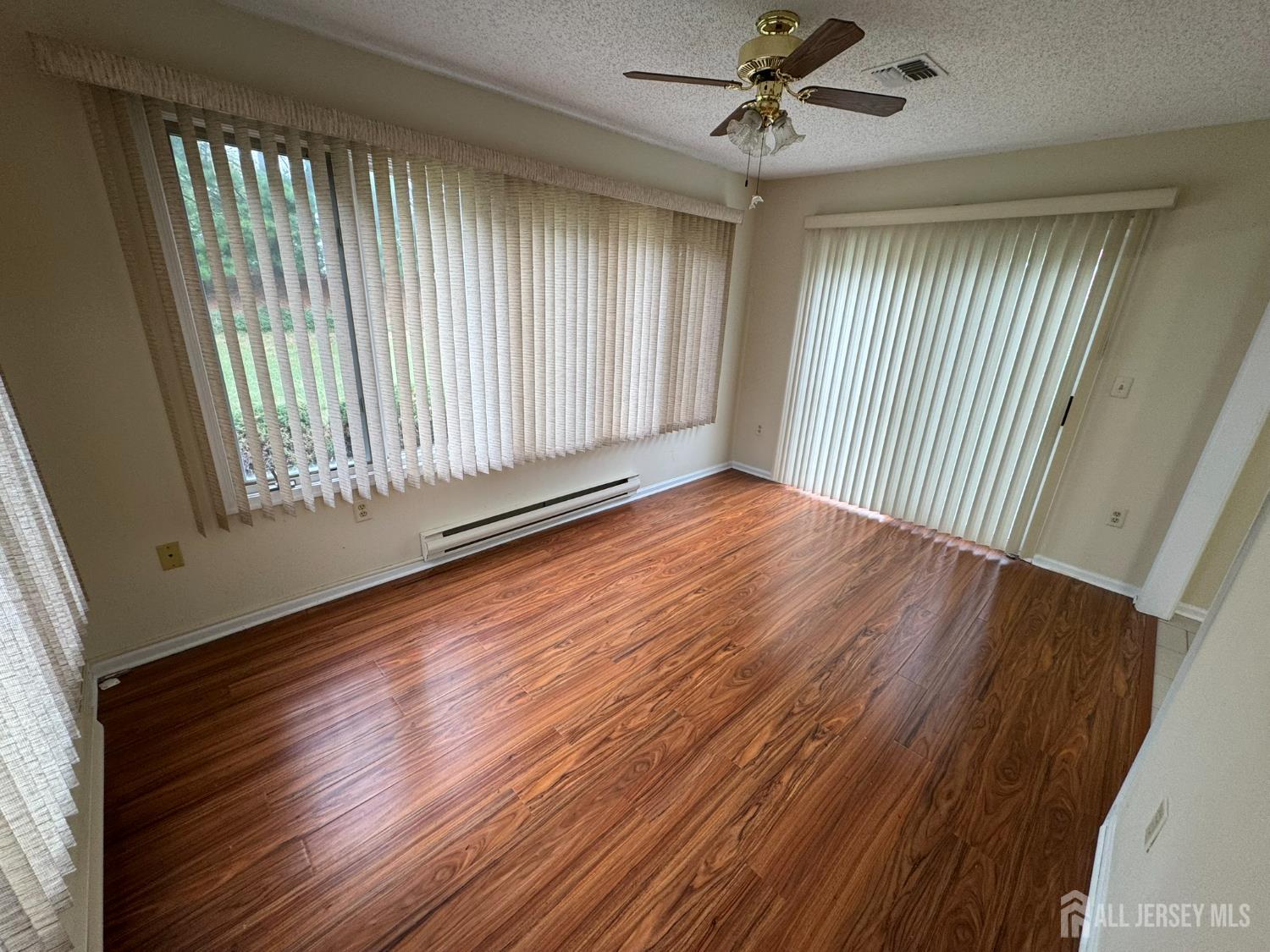 723 Mt Vernon Road, Unit A Monroe Township, NJ 08831 - Photo 9 of 19 a view of an empty room with wooden floor and a window