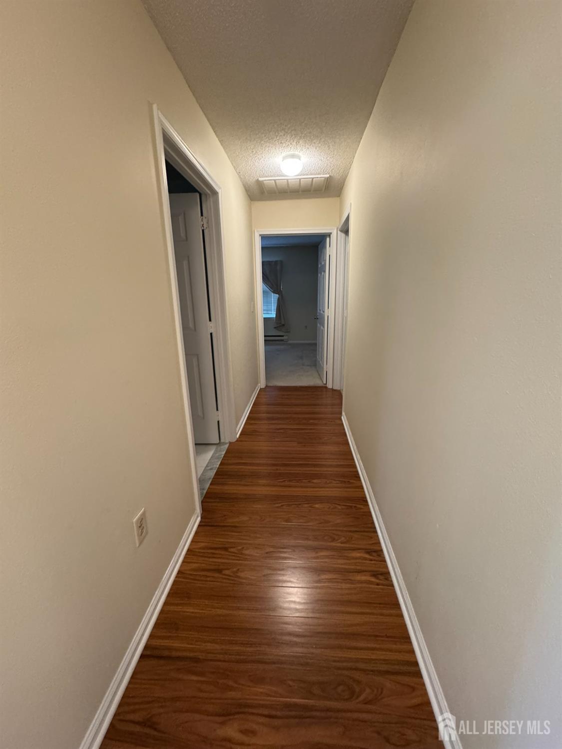 723 Mt Vernon Road, Unit A Monroe Township, NJ 08831 - Photo 10 of 19 a view of a hallway with wooden floor and staircase