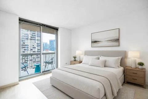 a bedroom with a large bed and a window