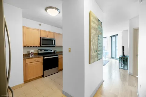 a kitchen with a refrigerator and a stove top oven