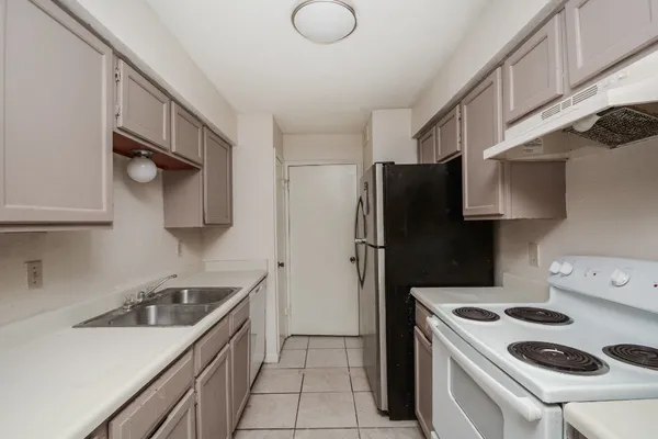 an empty room with a ceiling fan and a window