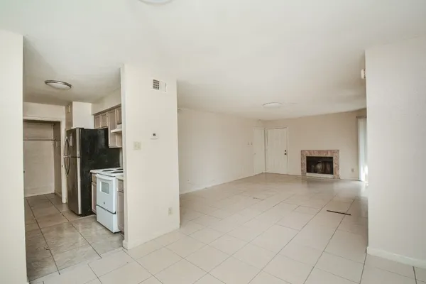 a view of a kitchen with a sink and a refrigerator