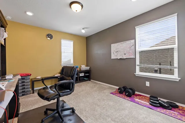 a bedroom with furniture and a window