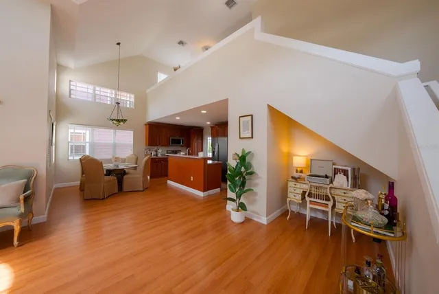 a living room with furniture gym equipment wooden floor and a large window