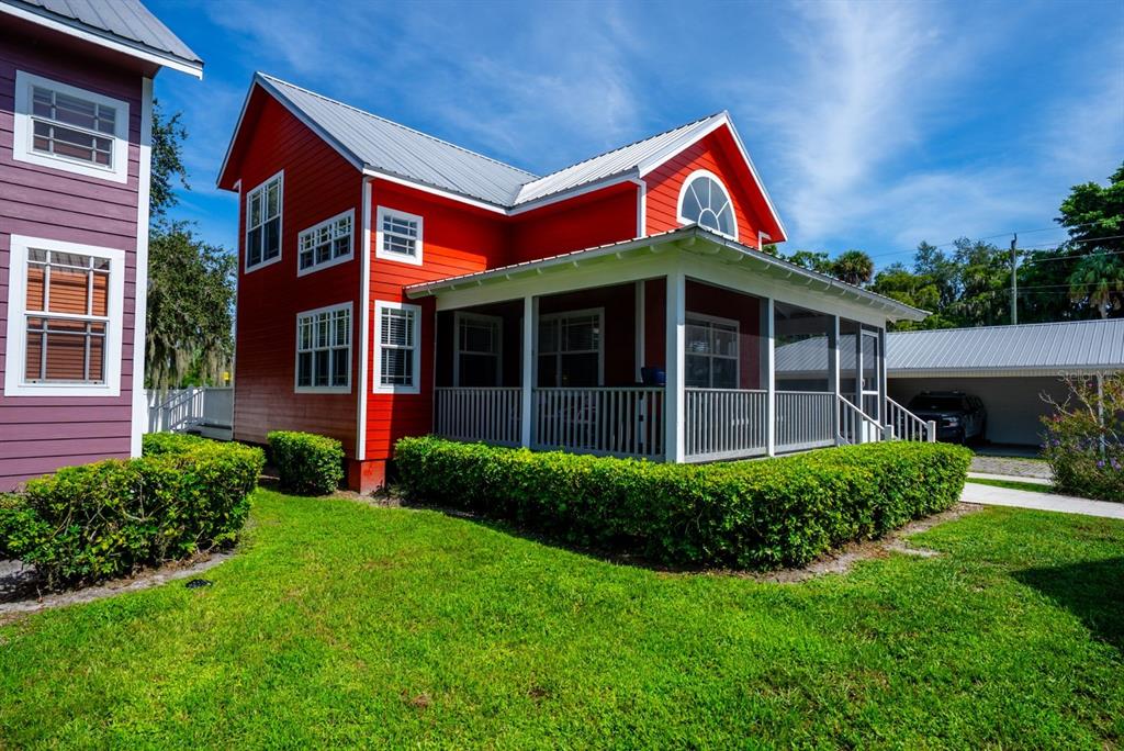 4334 Highway 441, Unit 24 Okeechobee, FL 34974 - Photo 2 of 40 a view of a brick house with a yard large tree and a large window