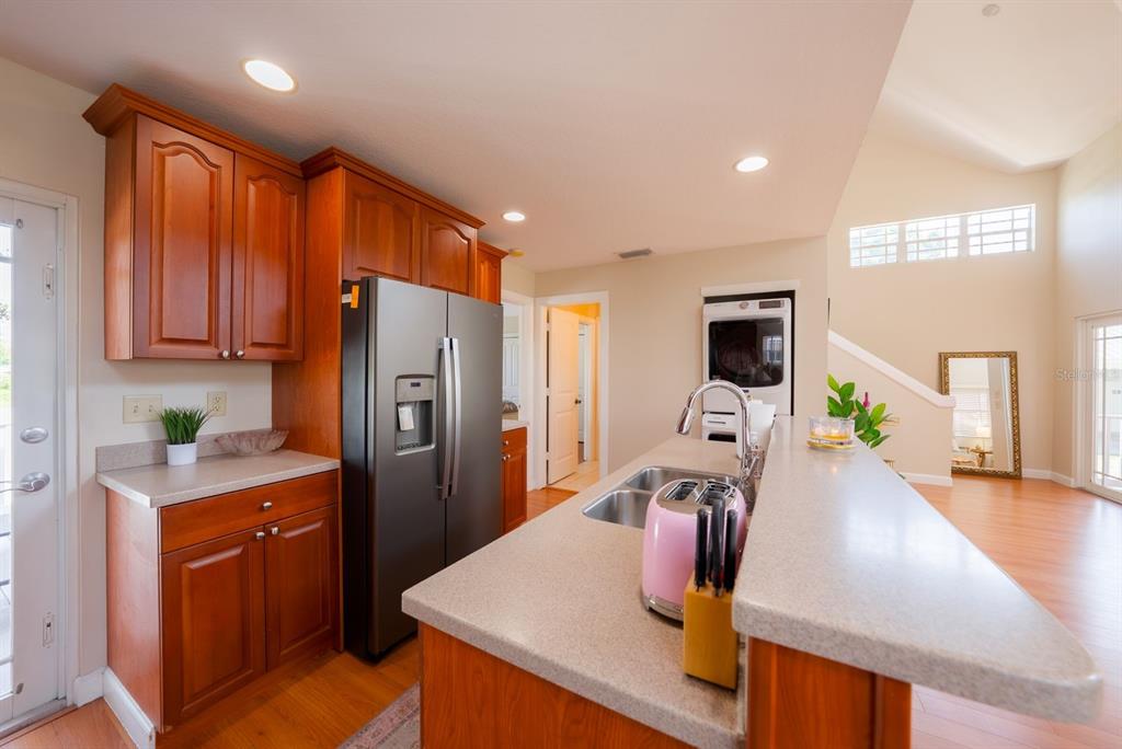 4334 Highway 441, Unit 24 Okeechobee, FL 34974 - Photo 21 of 40 a kitchen with stainless steel appliances wooden floor dining table and chairs
