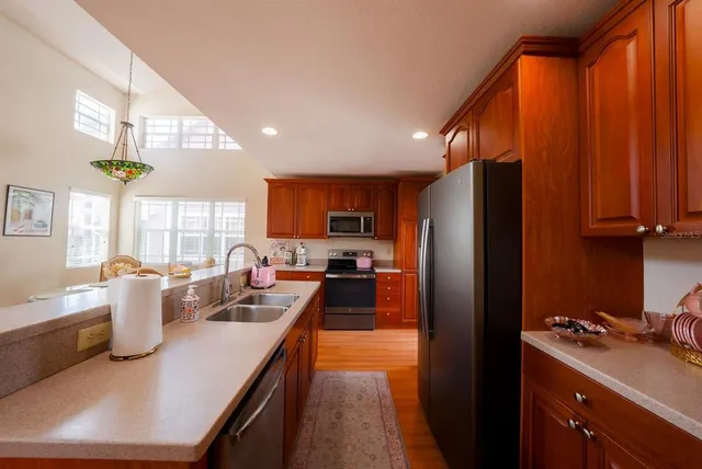 a kitchen with sink refrigerator and cabinets