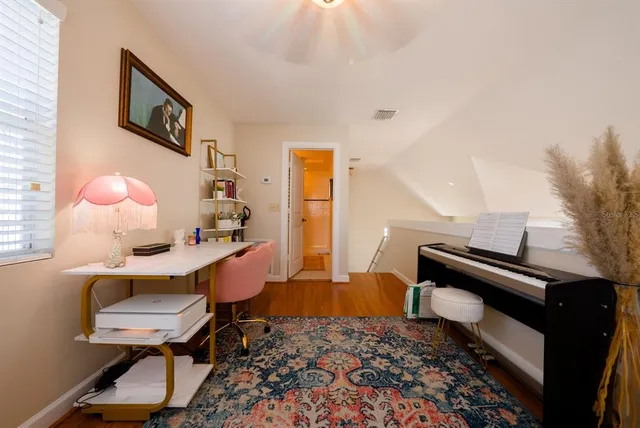 a living room with furniture and a piano