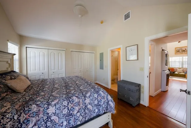a bedroom with a bed and wooden floor