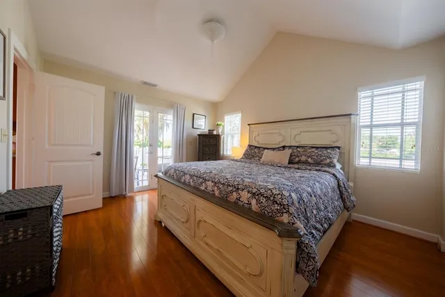 a bedroom with a bed and wooden floor