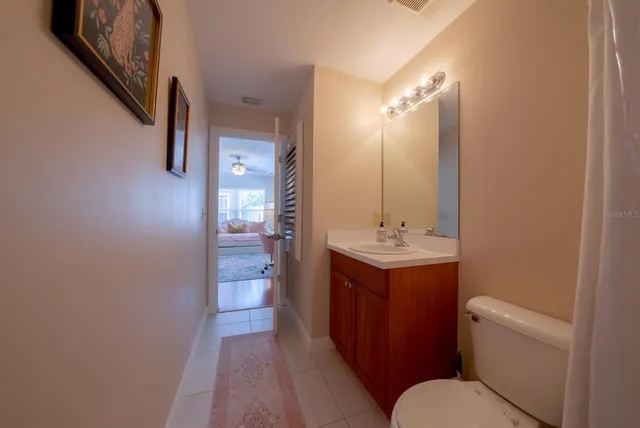 a bathroom with a sink and mirror with toilet