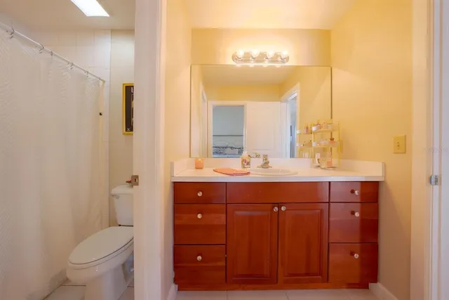 a bathroom with a double vanity sink toilet and a mirror