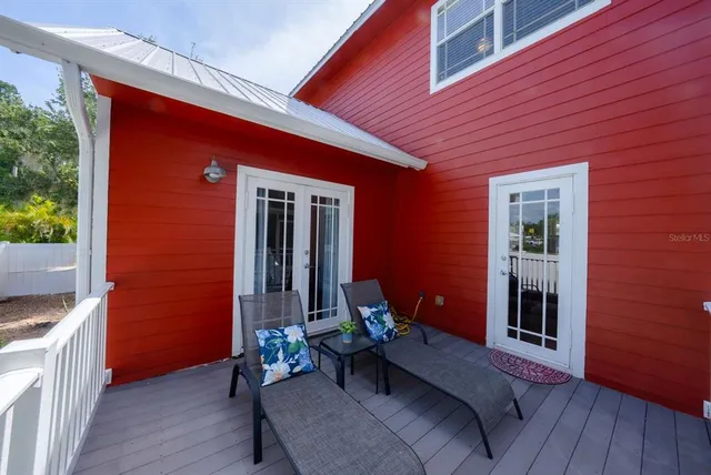 a balcony with furniture and wooden floor
