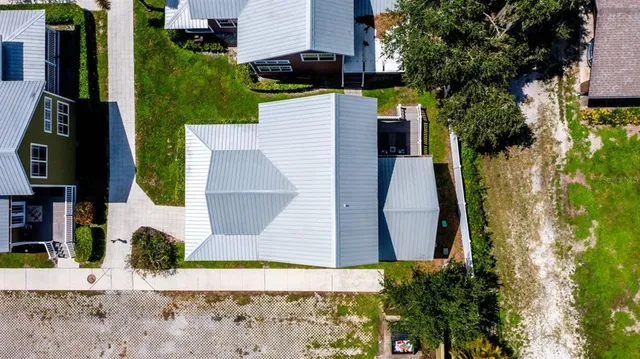 an aerial view of a house with a yard
