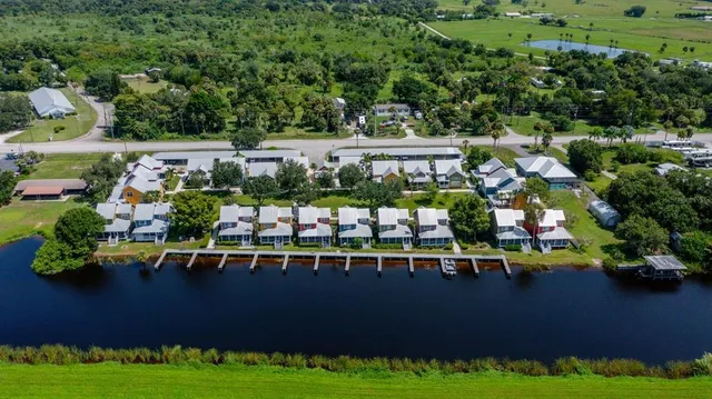 an aerial view of a house with a garden lake view
