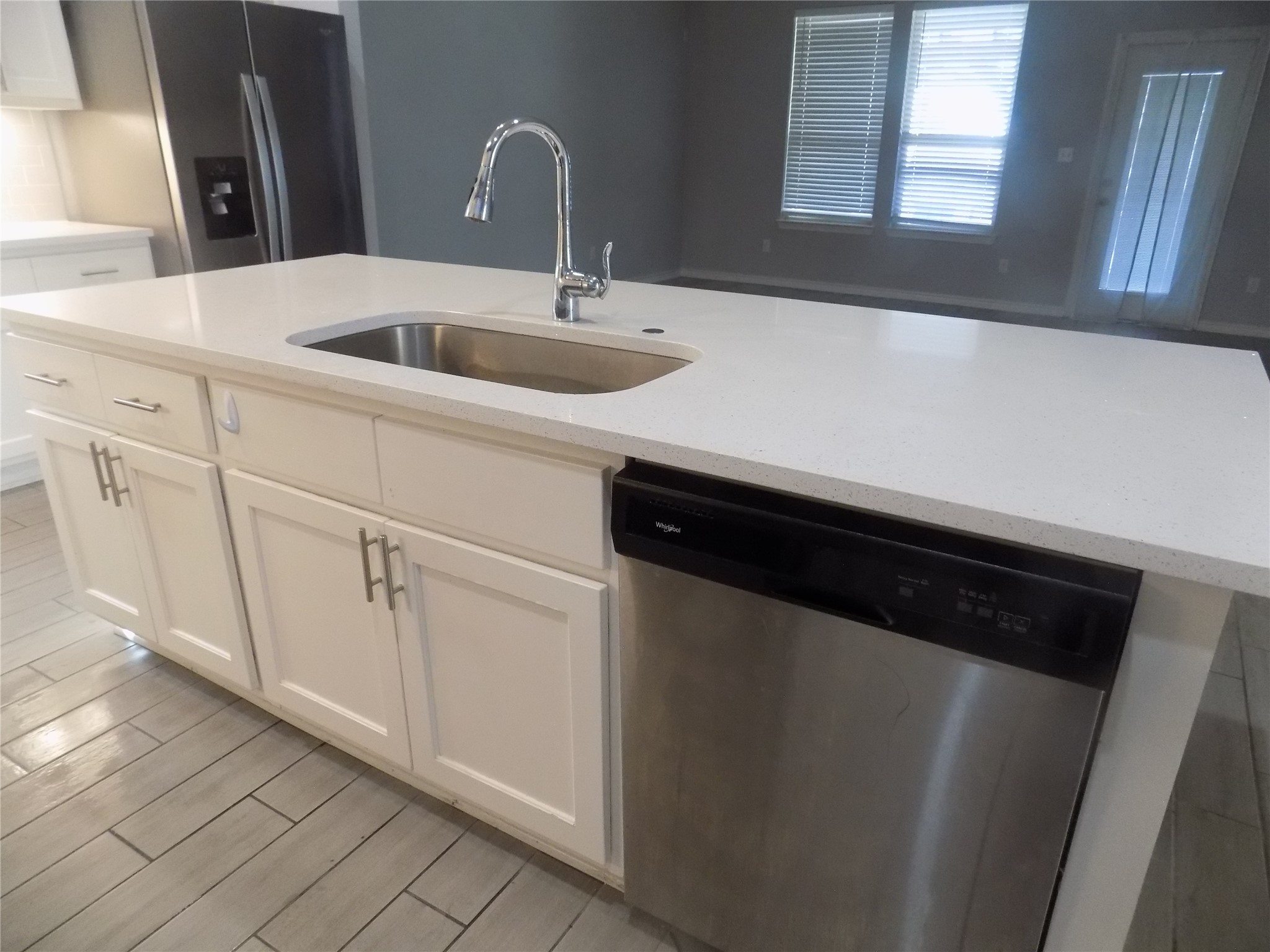 1133 Capra Lane Leander, TX 78641 - Photo 13 of 25 This modern kitchen features a spacious island, sleek appliances, and durable flooring.