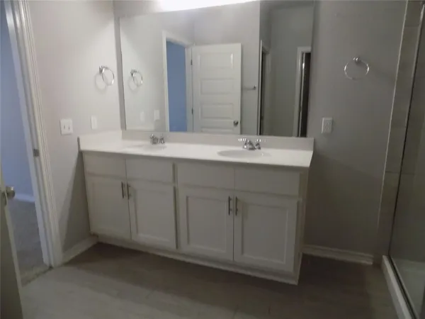a bathroom with a double vanity sink and a mirror