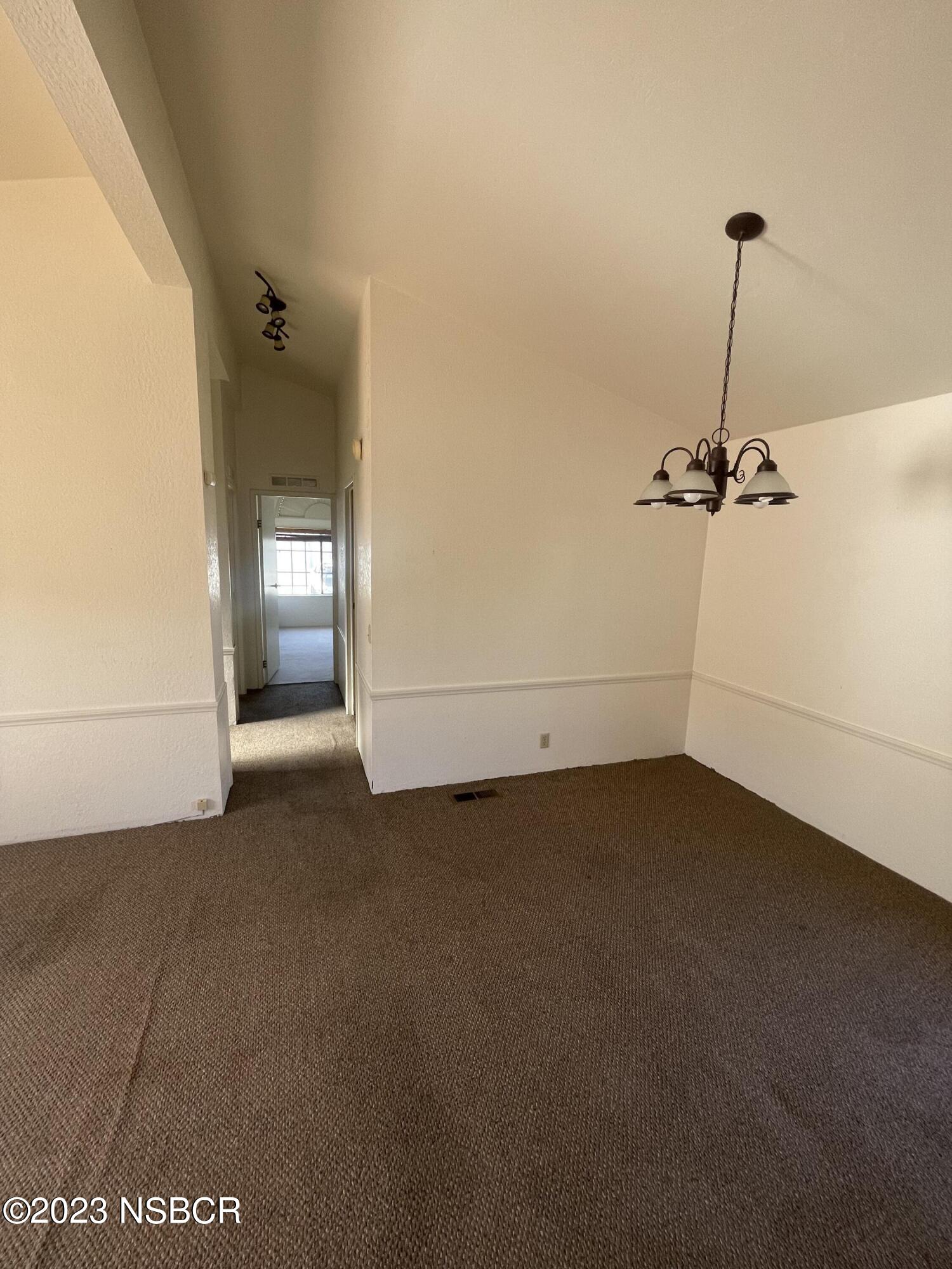 1317 V Street, Unit 114 Lompoc, CA 93436 - Photo 11 of 24 an empty room with a ceiling fan and a window