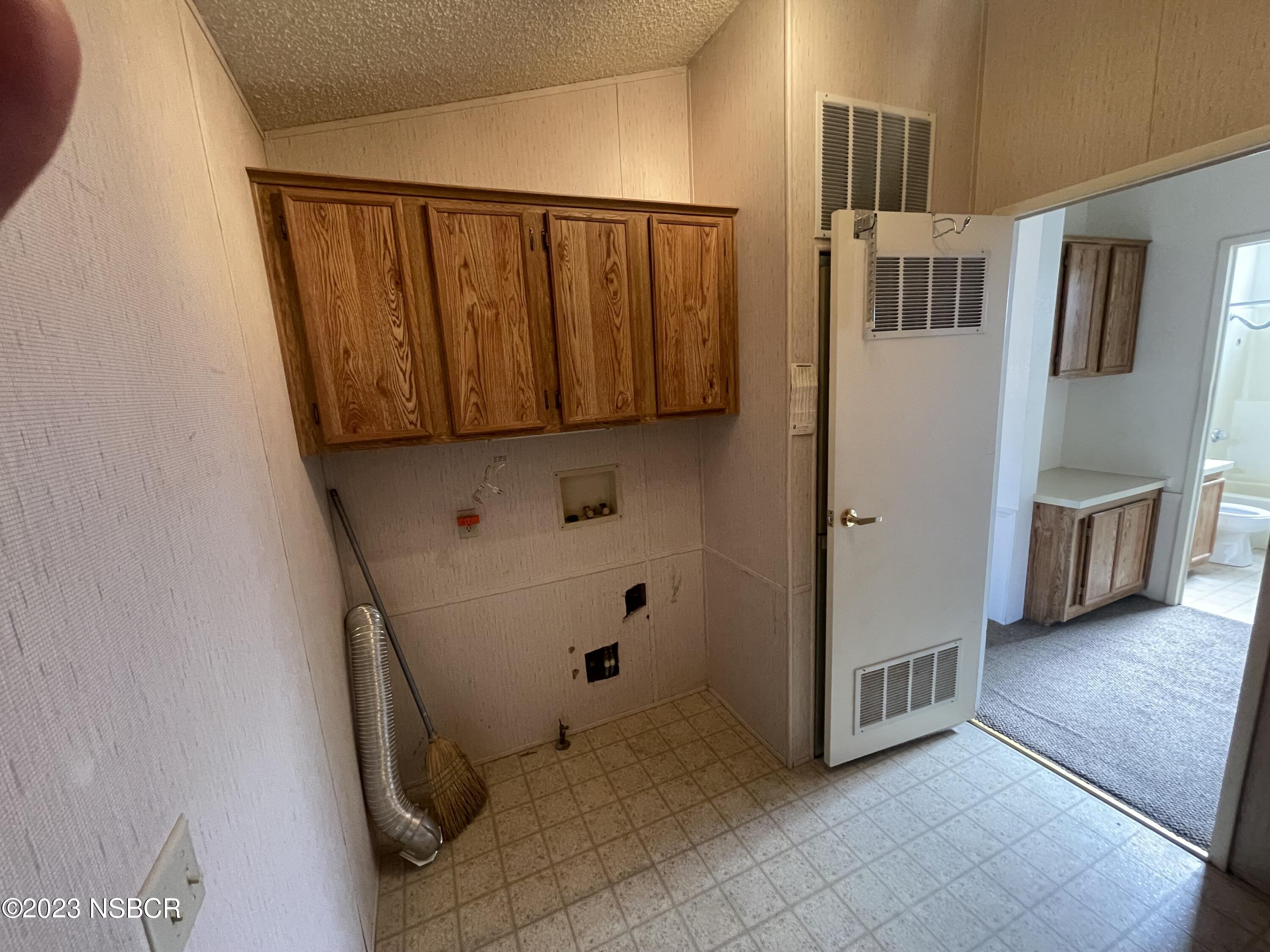1317 V Street, Unit 114 Lompoc, CA 93436 - Photo 15 of 24 a view of an entryway with wooden cabinet