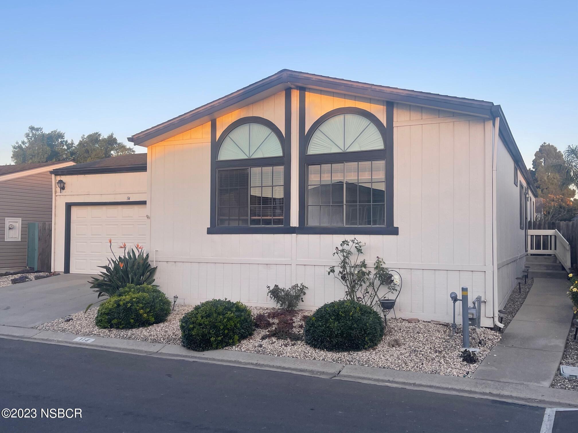 1317 V Street, Unit 114 Lompoc, CA 93436 - Photo 2 of 24 a front view of a house with garden