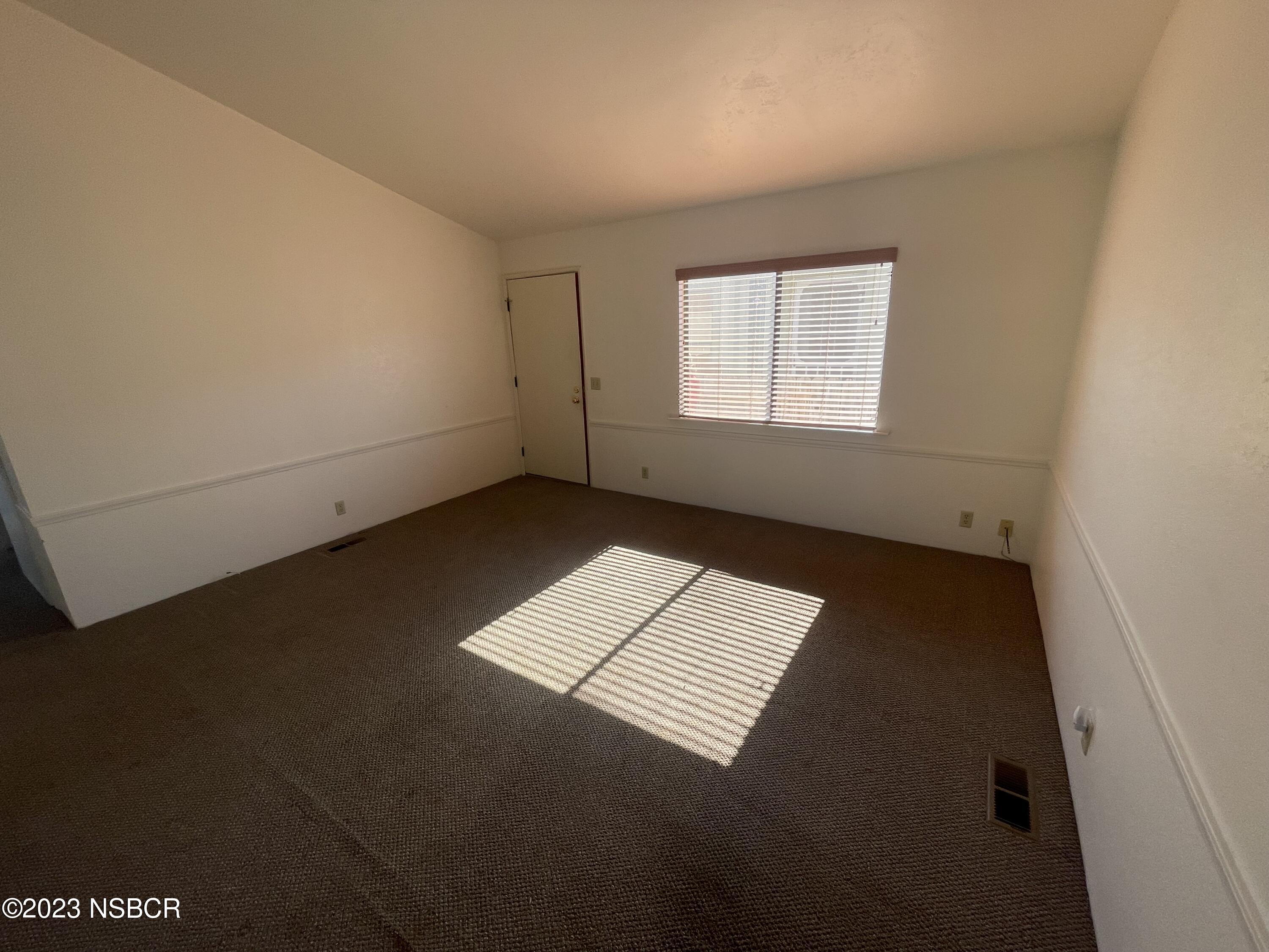 1317 V Street, Unit 114 Lompoc, CA 93436 - Photo 5 of 24 an empty room with a window