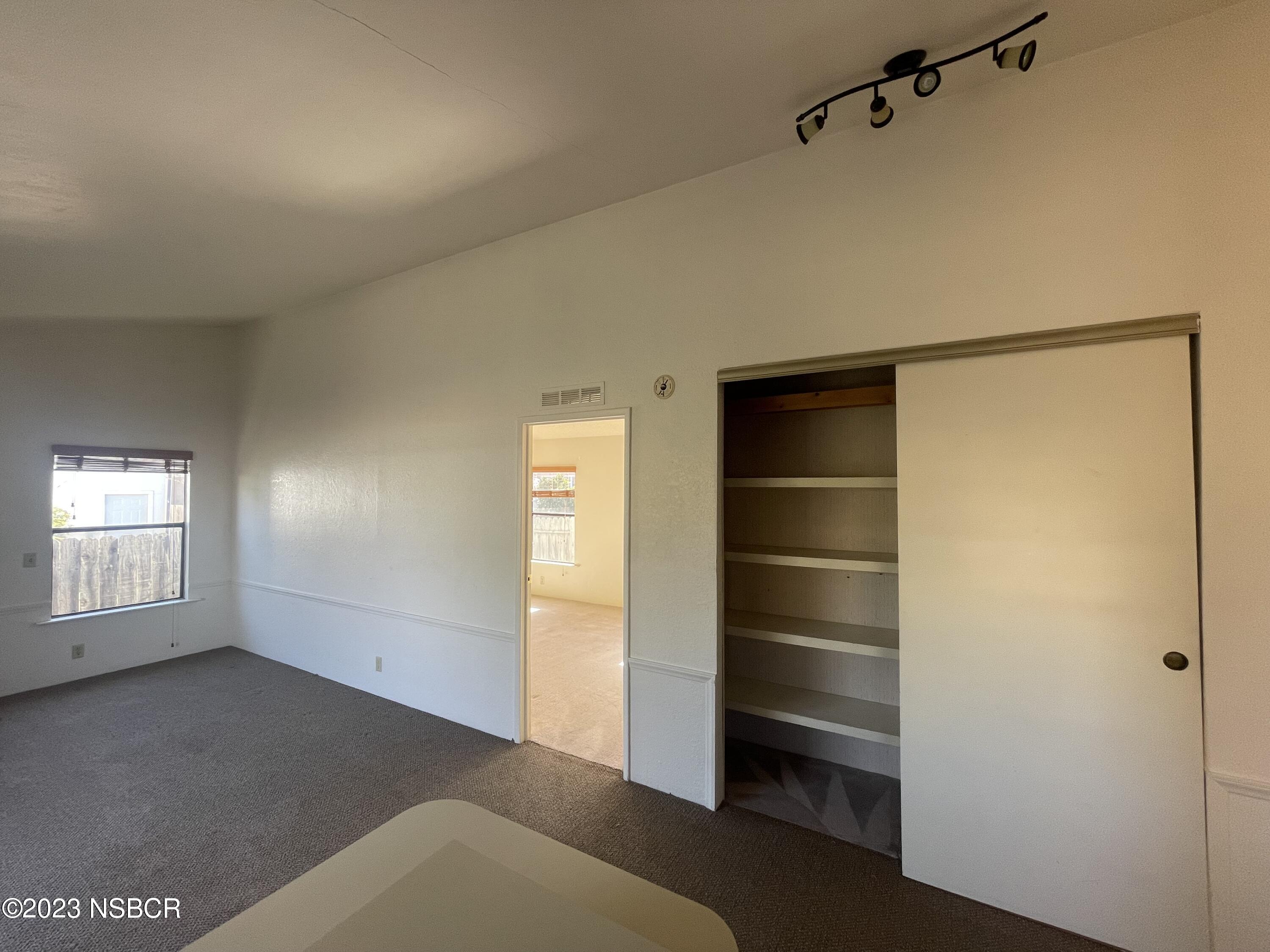 1317 V Street, Unit 114 Lompoc, CA 93436 - Photo 6 of 24 a view of an empty room with a window