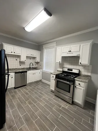 a kitchen with stainless steel appliances granite countertop a stove a sink dishwasher and a refrigerator