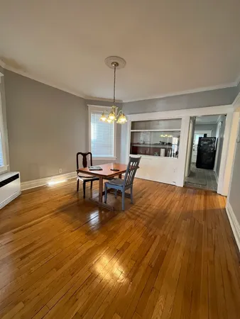 a dining room with furniture and wooden floor