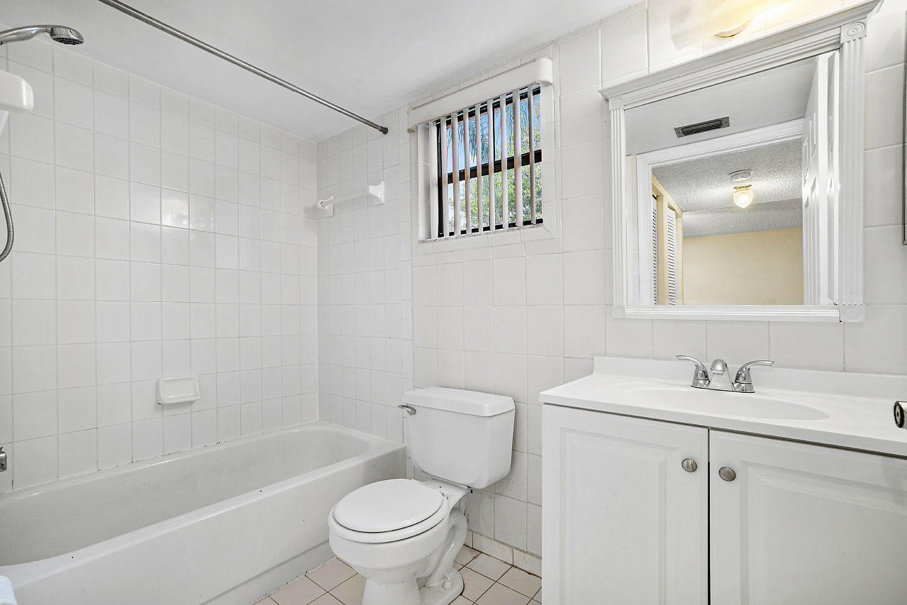 3050 Norwood Place, Unit N112 Boca Raton, FL 33431 - Photo 11 of 23 a bathroom with a sink toilet and shower