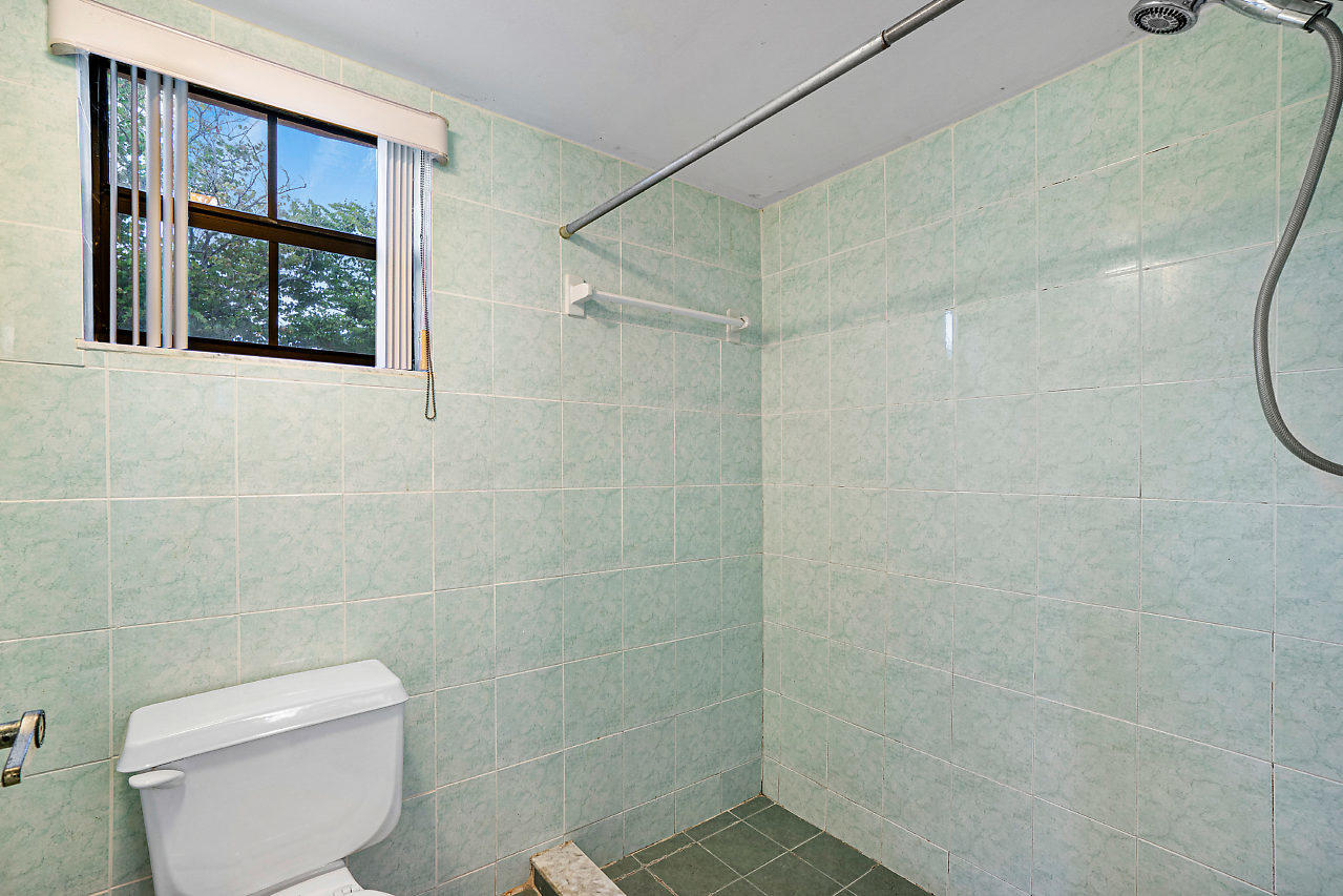3050 Norwood Place, Unit N112 Boca Raton, FL 33431 - Photo 15 of 23 a bathroom with a toilet and a shower