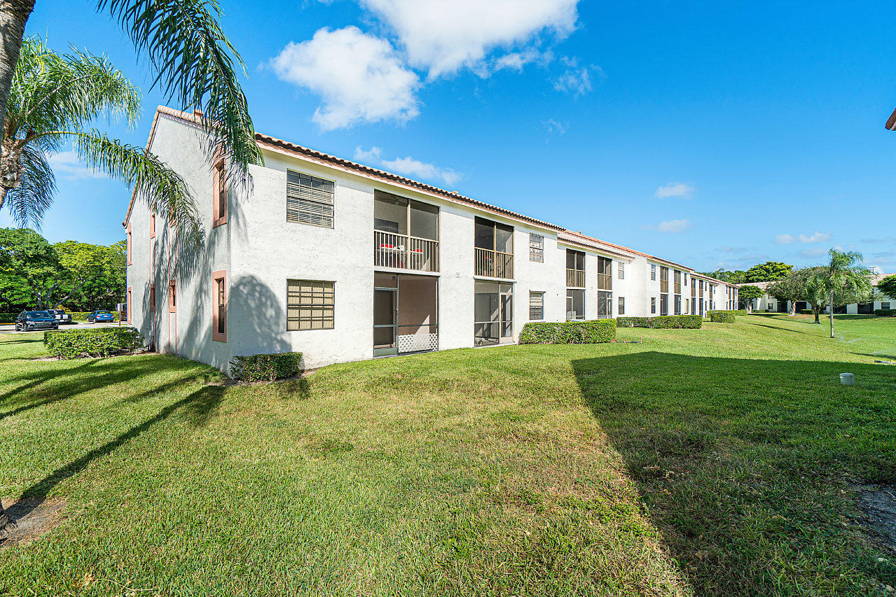 3050 Norwood Place, Unit N112 Boca Raton, FL 33431 - Photo 18 of 23 a view of a house with a yard
