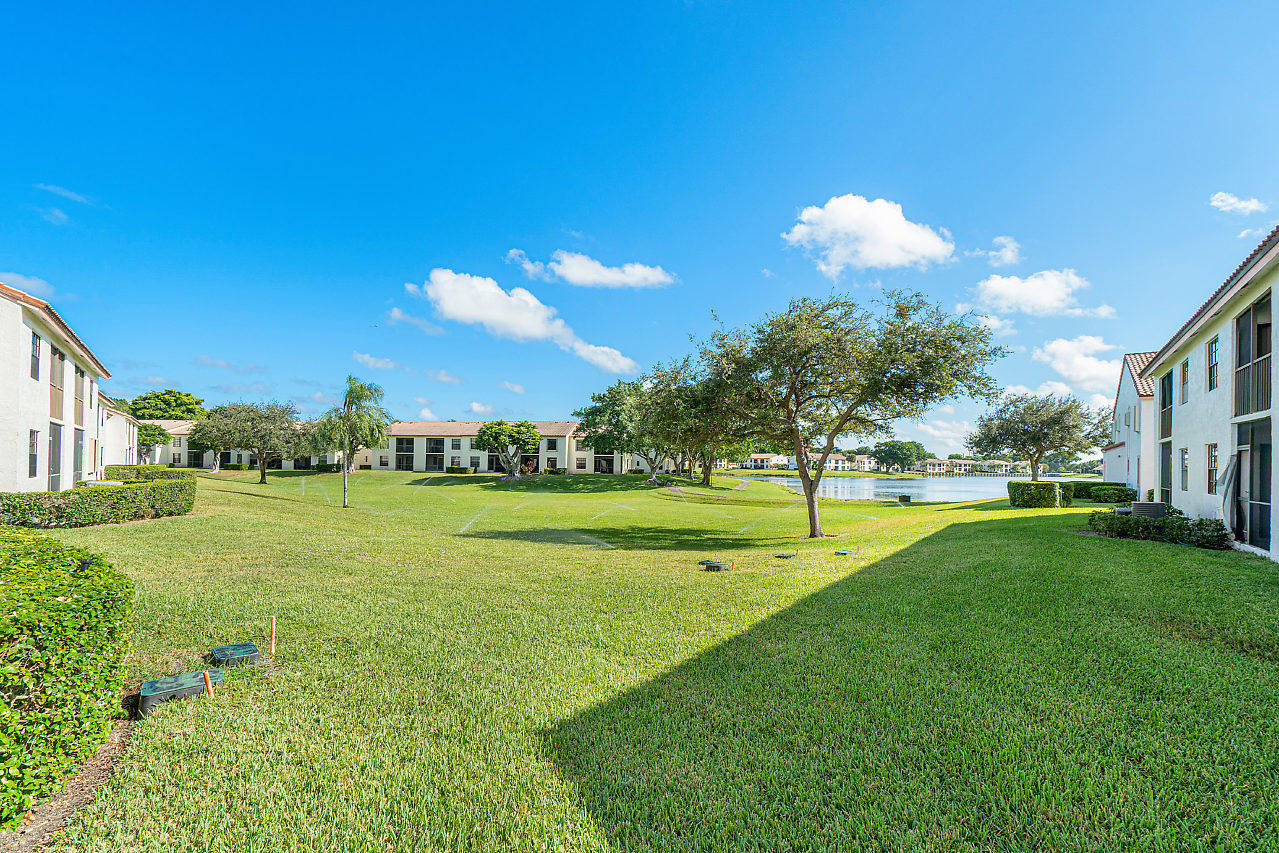3050 Norwood Place, Unit N112 Boca Raton, FL 33431 - Photo 20 of 23 a view of a golf course with a lake