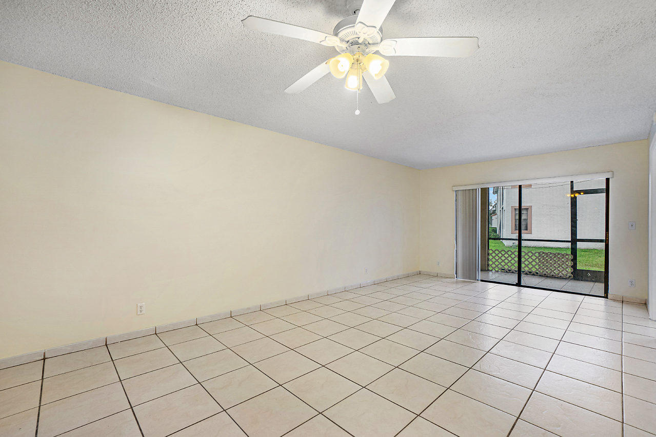3050 Norwood Place, Unit N112 Boca Raton, FL 33431 - Photo 2 of 23 an empty room with windows and fan