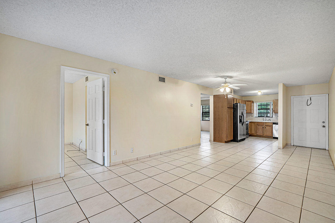 3050 Norwood Place, Unit N112 Boca Raton, FL 33431 - Photo 5 of 23 a view of an empty room and chandelier