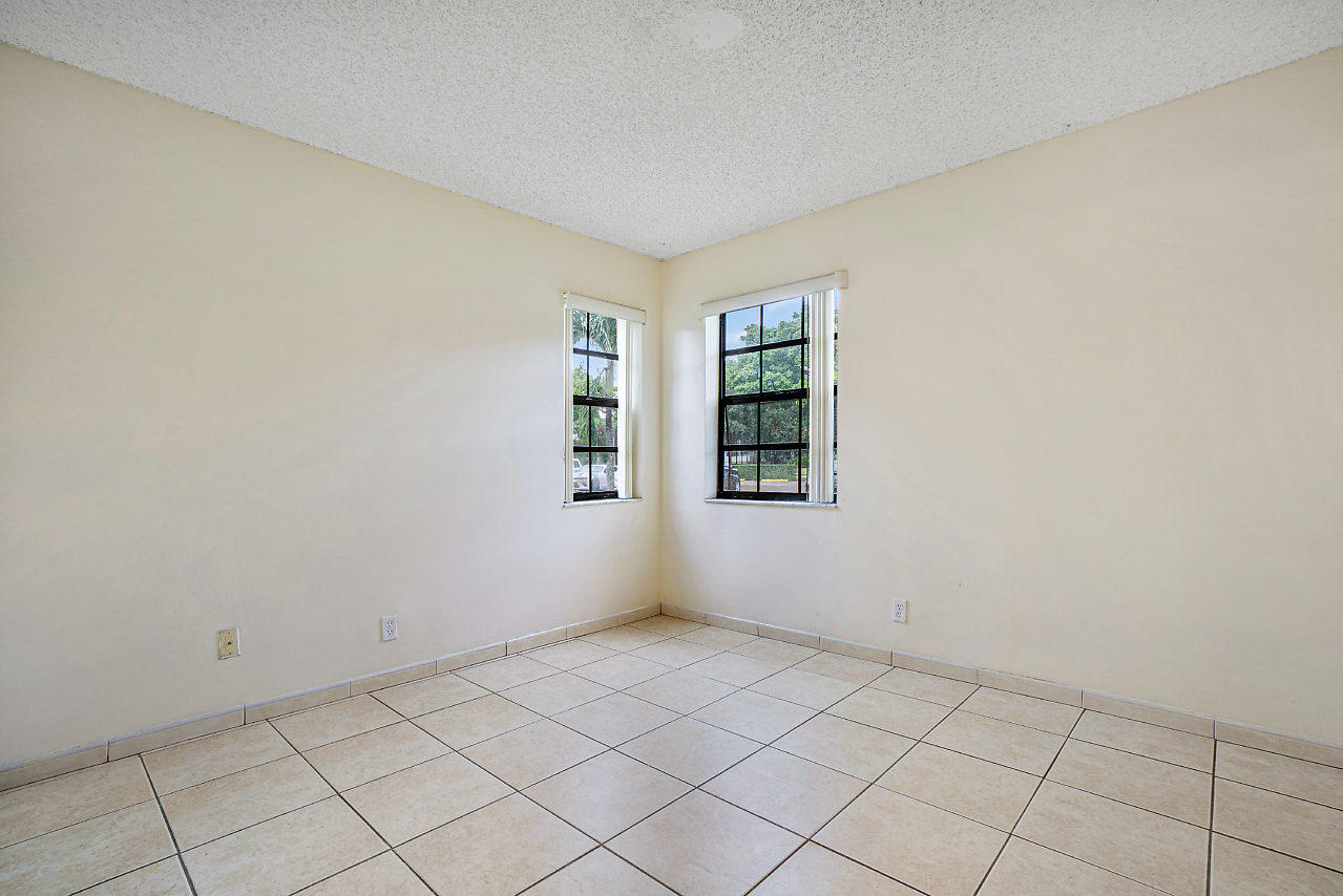 3050 Norwood Place, Unit N112 Boca Raton, FL 33431 - Photo 10 of 23 an empty room with windows