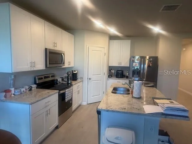 a kitchen with a sink stove and refrigerator