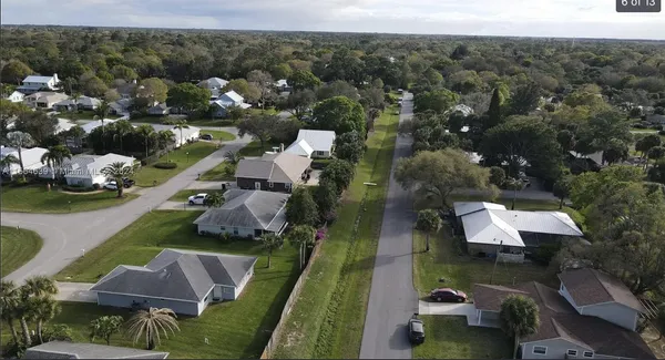 an aerial view of house with a yard
