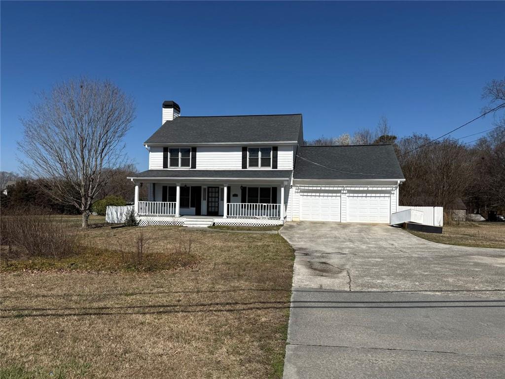 3383 Hamilton Mill Road Buford, GA 30519 - Photo 1 of 18 a front view of a house with a yard