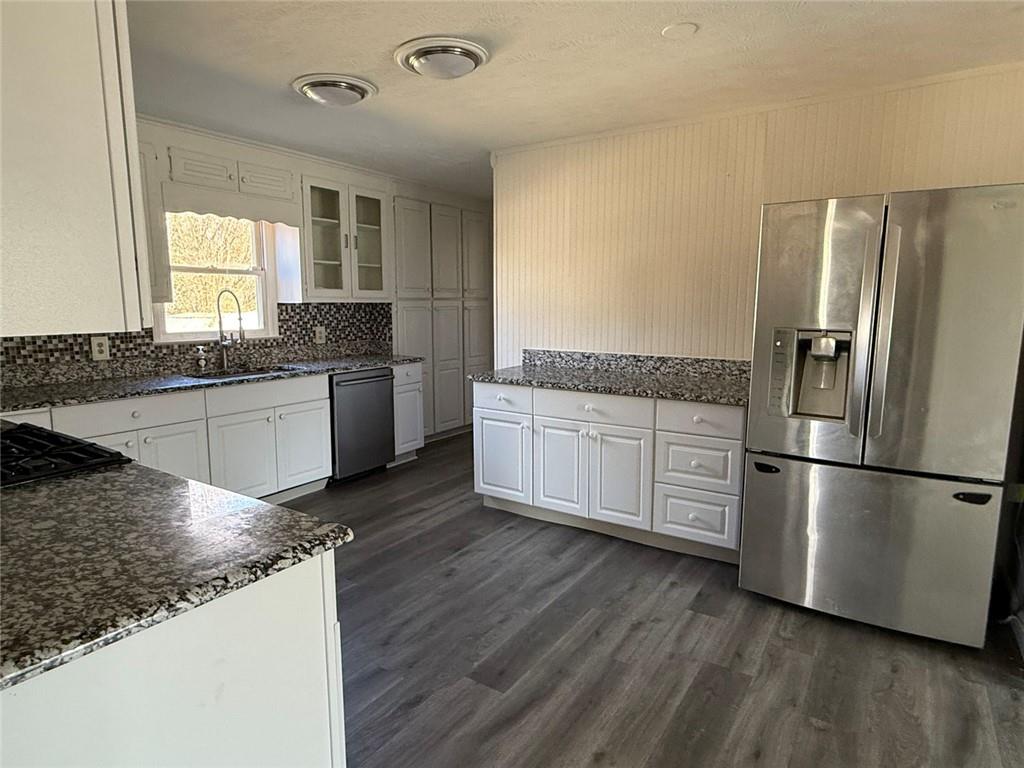 3383 Hamilton Mill Road Buford, GA 30519 - Photo 11 of 18 a kitchen with stainless steel appliances granite countertop a refrigerator a stove and a sink