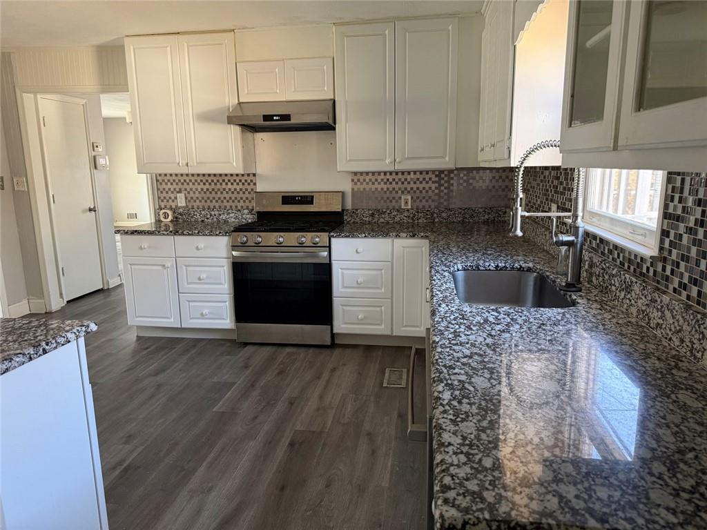 3383 Hamilton Mill Road Buford, GA 30519 - Photo 12 of 18 a kitchen with a stove a sink and a refrigerator
