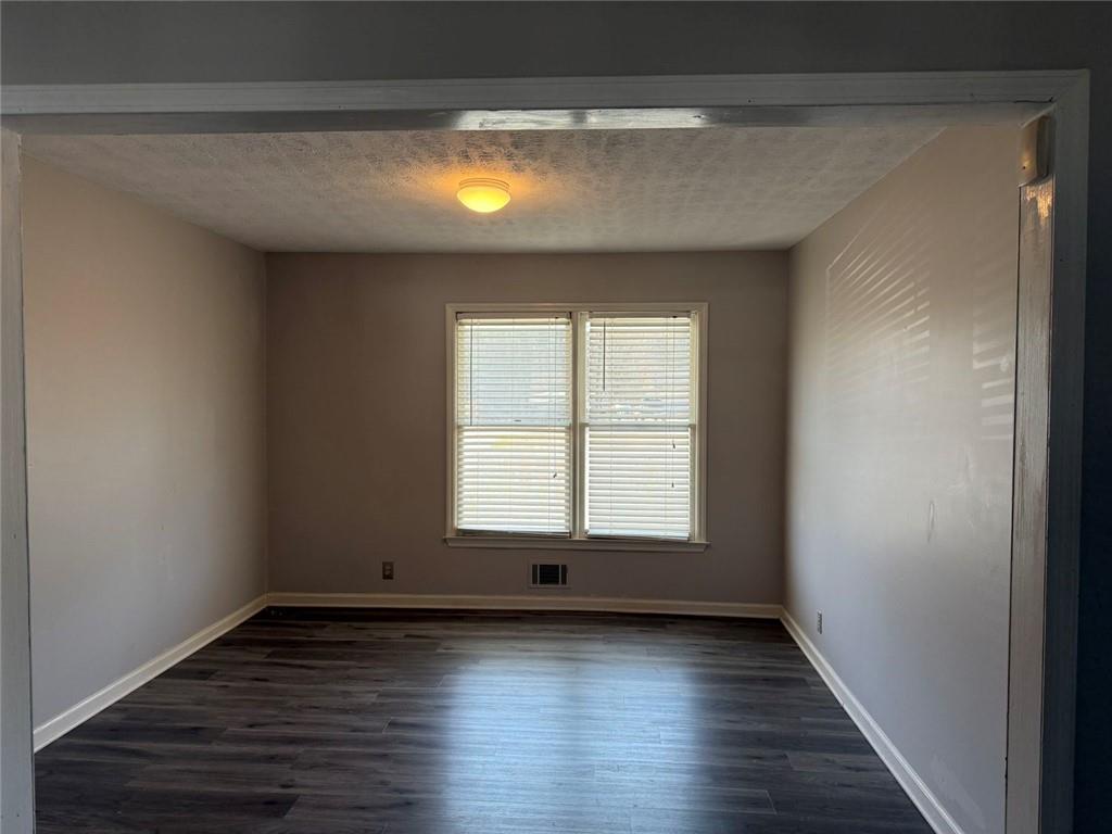 3383 Hamilton Mill Road Buford, GA 30519 - Photo 14 of 18 a view of an empty room with wooden floor and a window