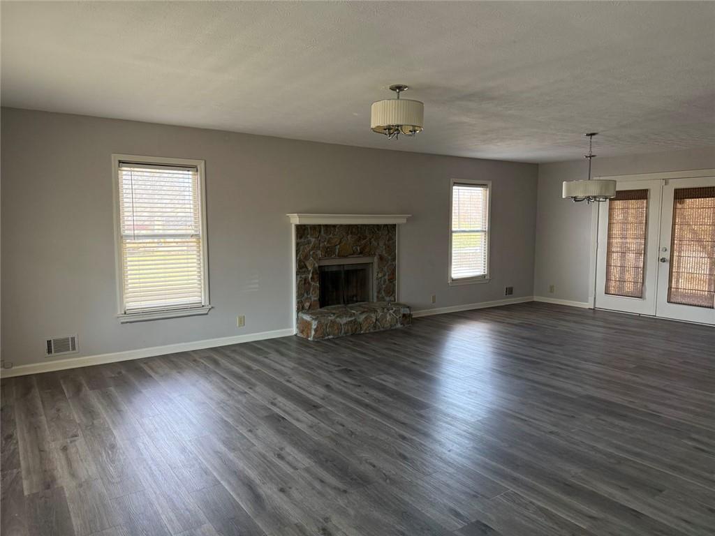 3383 Hamilton Mill Road Buford, GA 30519 - Photo 17 of 18 an empty room with wooden floor fireplace and windows