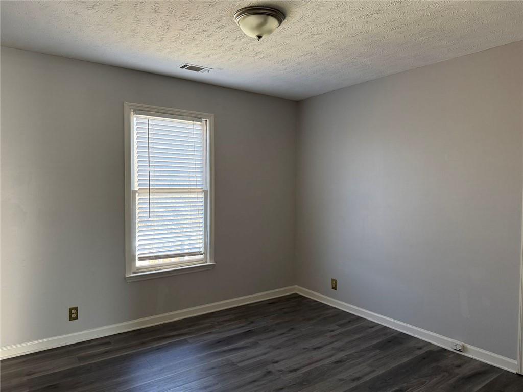 3383 Hamilton Mill Road Buford, GA 30519 - Photo 3 of 18 a view of an empty room with wooden floor and a window