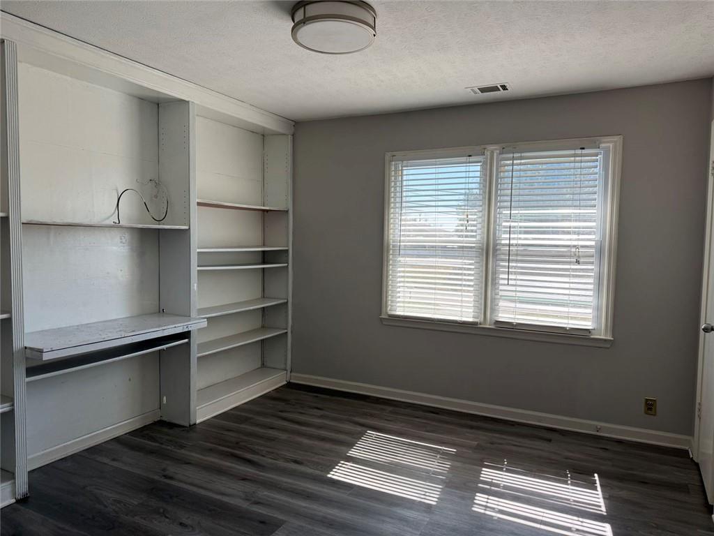 3383 Hamilton Mill Road Buford, GA 30519 - Photo 4 of 18 a room with wooden floor closet and windows