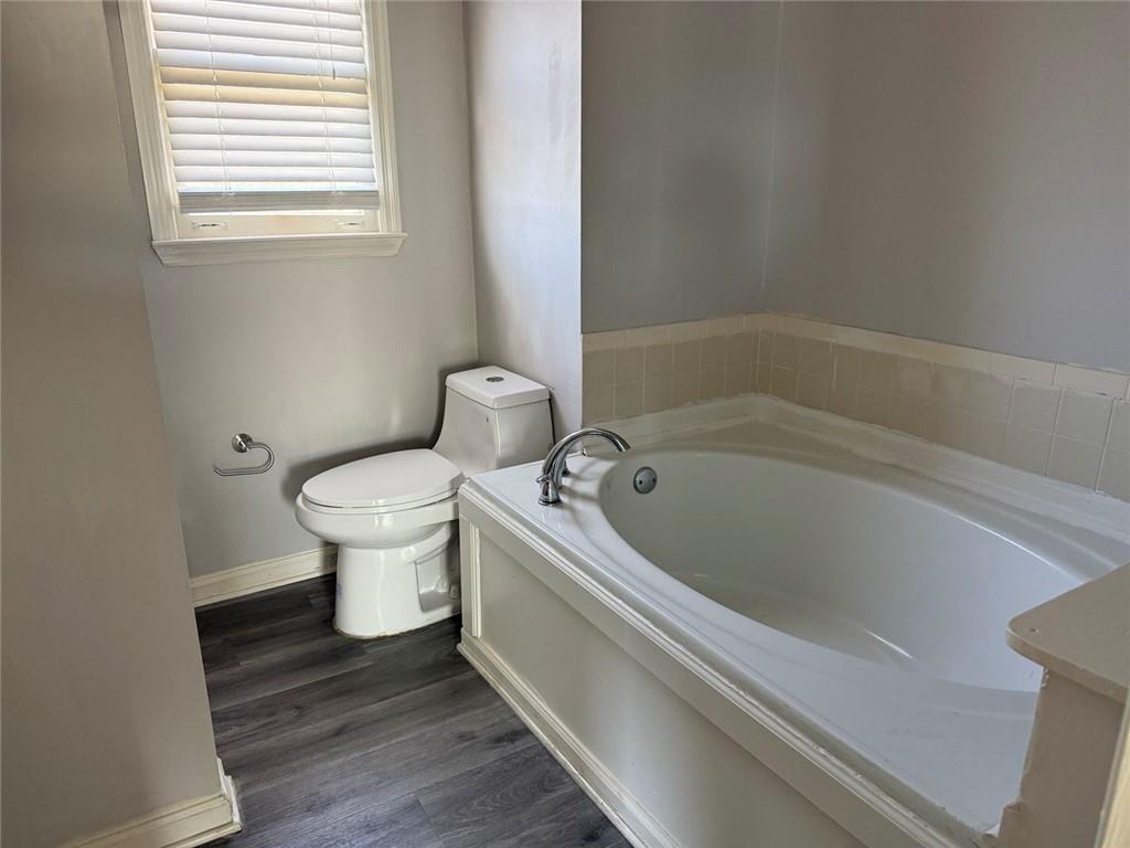 3383 Hamilton Mill Road Buford, GA 30519 - Photo 7 of 18 a bathroom with a toilet and a bathtub